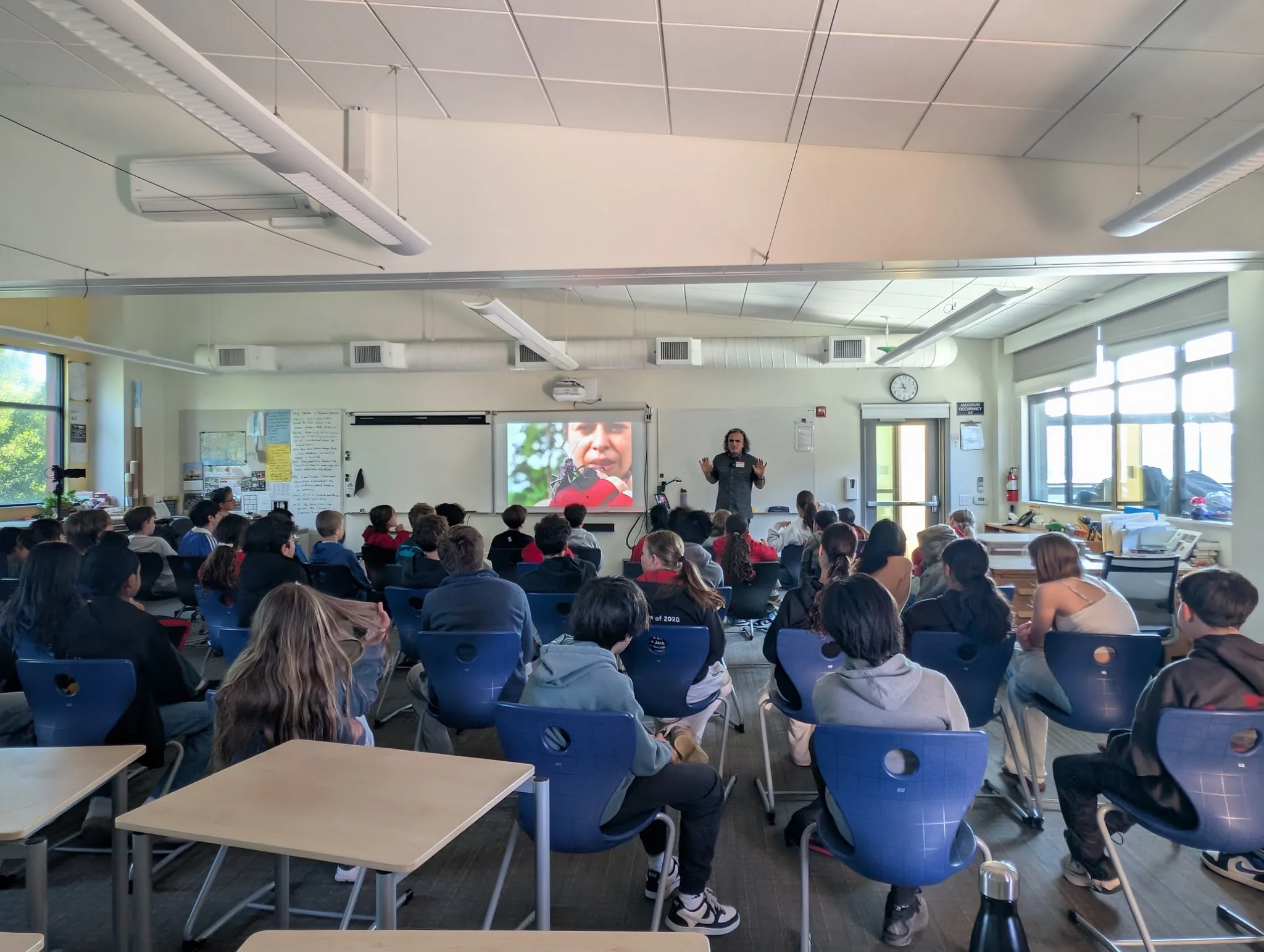 Students seated in a classroom during a Marc Hors photographic storytelling presentation.